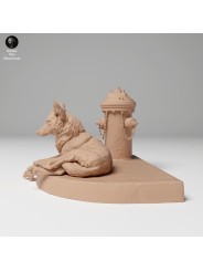 Coyote resting next to a fire hydrant